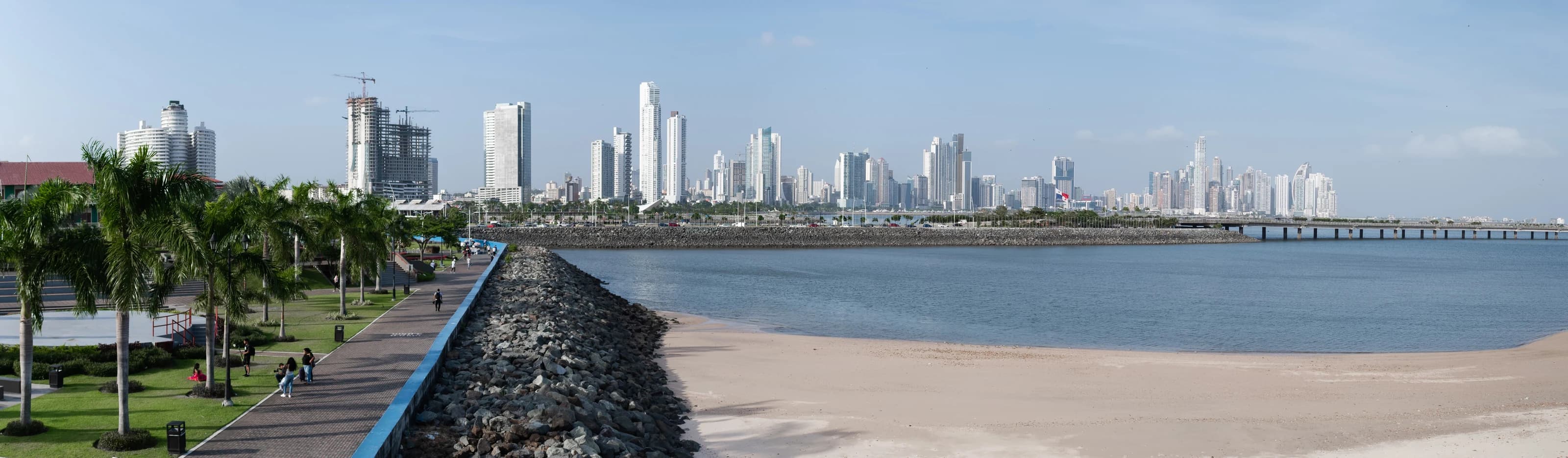 Panama City waterfront with a palm-lined promenade, the bay and high-rise buildings.